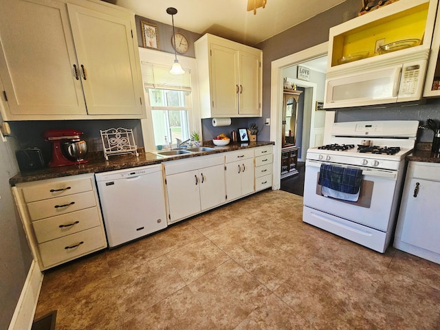 822 4th Ave, Madison, MN 56256 - kitchen with dark countertops, a sink, white appliances, and white cabinetry