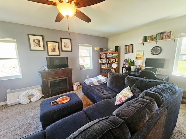 822 4th Ave, Madison, MN 56256 - carpeted living area with a ceiling fan and a glass covered fireplace