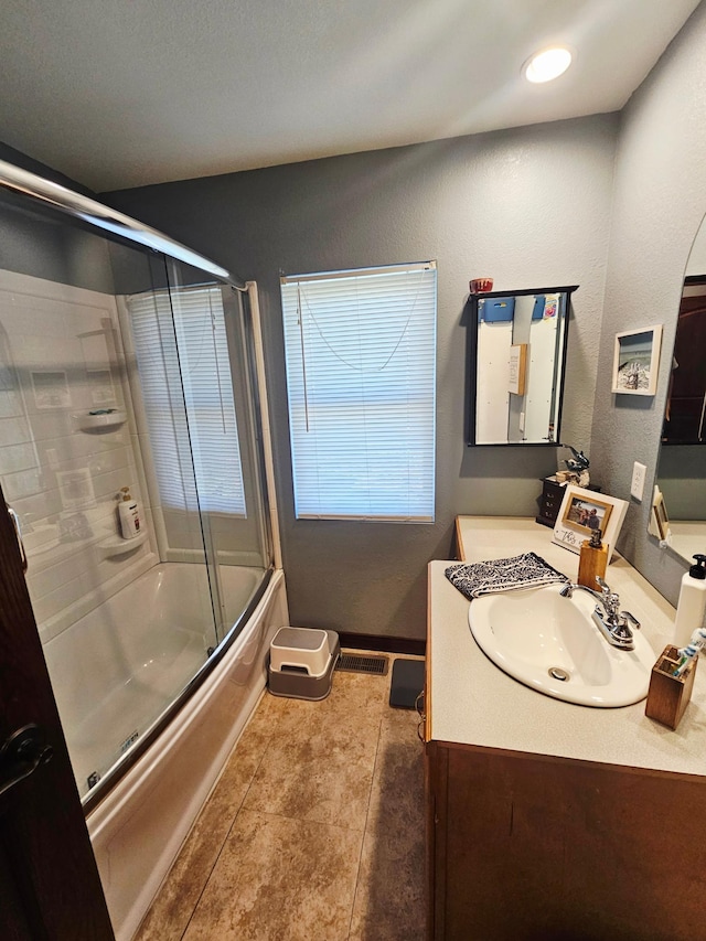 822 4th Ave, Madison, MN 56256 - bathroom with vanity, enclosed tub / shower combo, tile patterned flooring, and visible vents