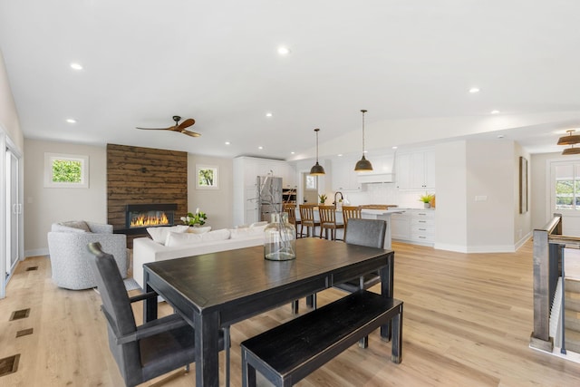3124 Linden Cir NW, Prior Lake, MN 55372 - dining space with a ceiling fan, light wood-style floors, a fireplace, recessed lighting, and baseboards