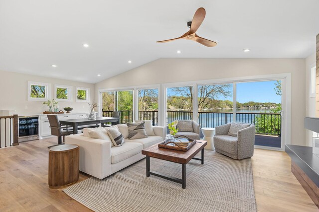 3124 Linden Cir NW, Prior Lake, MN 55372 - living area with beverage cooler, plenty of natural light, a water view, light wood-style floors, and lofted ceiling