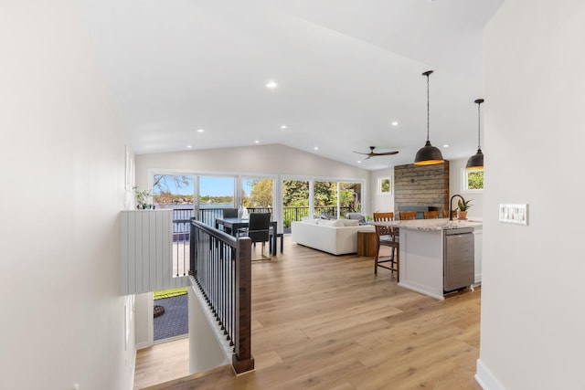 3124 Linden Cir NW, Prior Lake, MN 55372 - kitchen featuring stainless steel dishwasher, vaulted ceiling, recessed lighting, open floor plan, and a kitchen breakfast bar