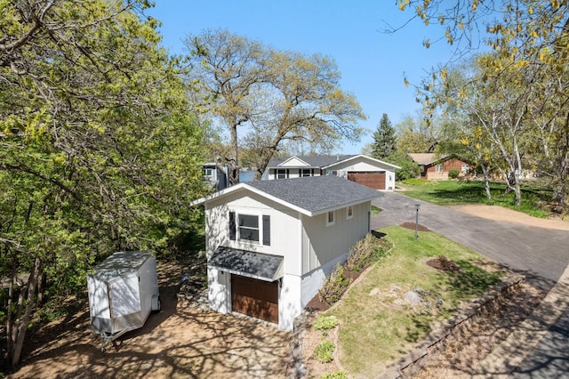 3124 Linden Cir NW, Prior Lake, MN 55372 - view of property exterior featuring roof with shingles, an outbuilding, and a lawn