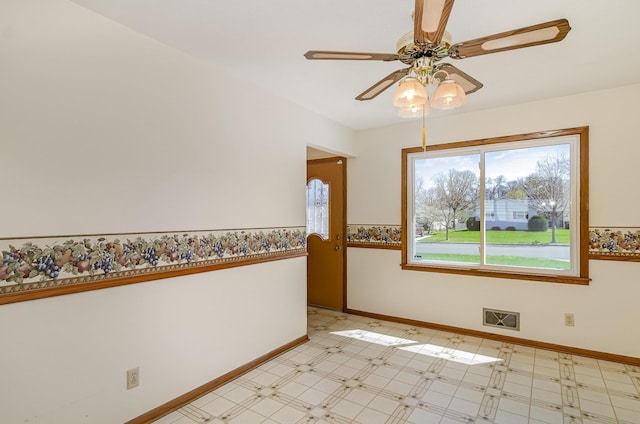 unfurnished room with visible vents, light floors, ceiling fan, and baseboards