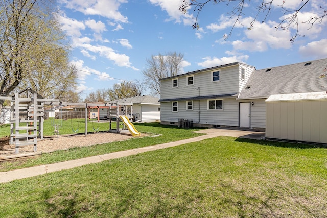 rear view of house with a storage unit, central AC, a playground, an outdoor structure, and a lawn