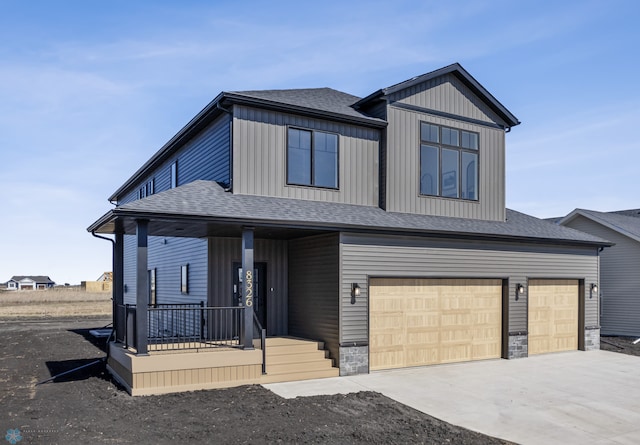 view of front of home with a porch, an attached garage, driveway, and a shingled roof
