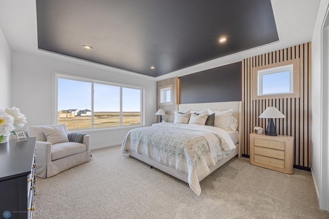 bedroom with baseboards, multiple windows, and light carpet
