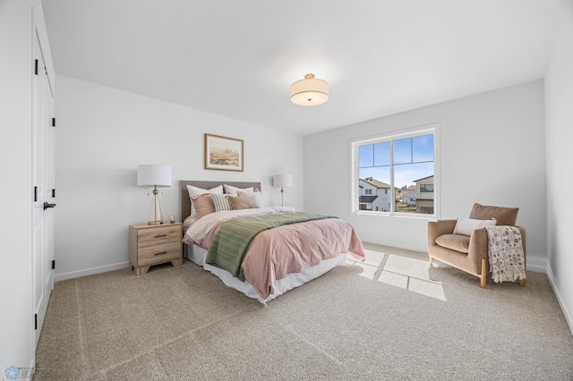 carpeted bedroom featuring baseboards