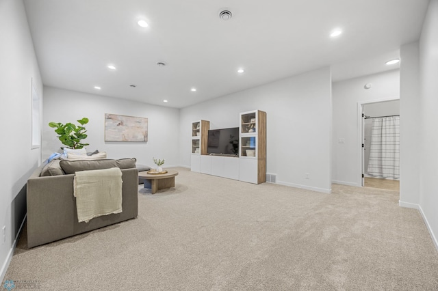 carpeted living room with baseboards, recessed lighting, and visible vents