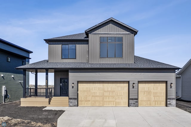 craftsman-style home featuring roof with shingles, an attached garage, stone siding, concrete driveway, and covered porch