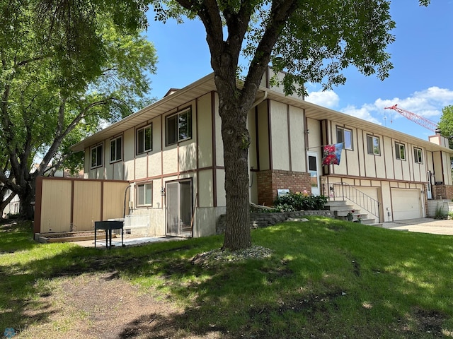 2323 4th Ave S, Moorhead, MN 56560 - view of building exterior featuring a garage and driveway