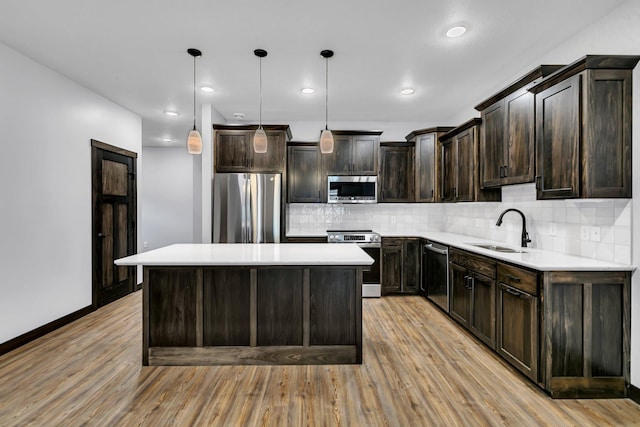 215 Butler St, Litchfield, MN 55355 - kitchen with appliances with stainless steel finishes, light wood-type flooring, dark brown cabinetry, tasteful backsplash, and light countertops