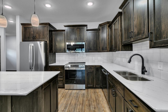 215 Butler St, Litchfield, MN 55355 - kitchen featuring stainless steel appliances, light wood finished floors, backsplash, light stone counters, and recessed lighting