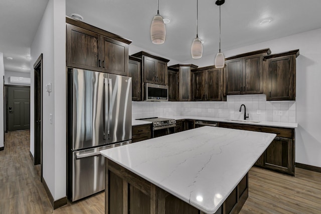 215 Butler St, Litchfield, MN 55355 - kitchen featuring appliances with stainless steel finishes, dark brown cabinets, tasteful backsplash, and light wood-style floors