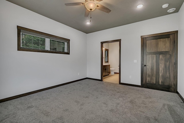 215 Butler St, Litchfield, MN 55355 - unfurnished bedroom featuring light carpet, ensuite bath, and ceiling fan