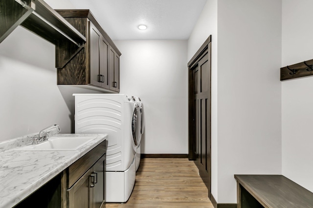 215 Butler St, Litchfield, MN 55355 - laundry room with cabinet space, separate washer and dryer, and light wood-style floors