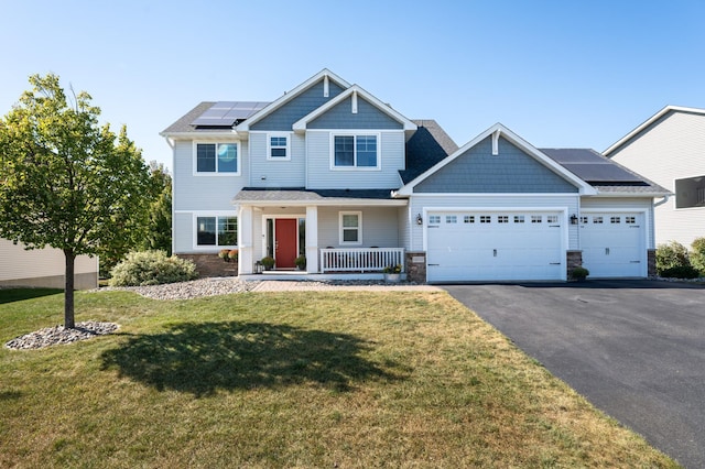 19717 Hazel Nut Ave, Lakeville, MN 55044 - craftsman inspired home with a porch, asphalt driveway, a garage, roof mounted solar panels, and a front lawn