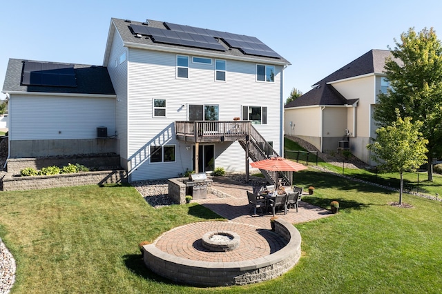 19717 Hazel Nut Ave, Lakeville, MN 55044 - rear view of property with a patio area, an outdoor fire pit, roof mounted solar panels, a deck, and stairs