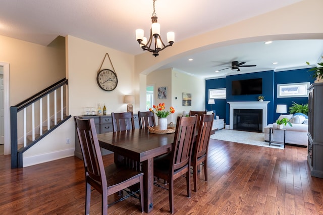 19717 Hazel Nut Ave, Lakeville, MN 55044 - dining space with a ceiling fan, dark wood finished floors, a fireplace, stairway, and arched walkways