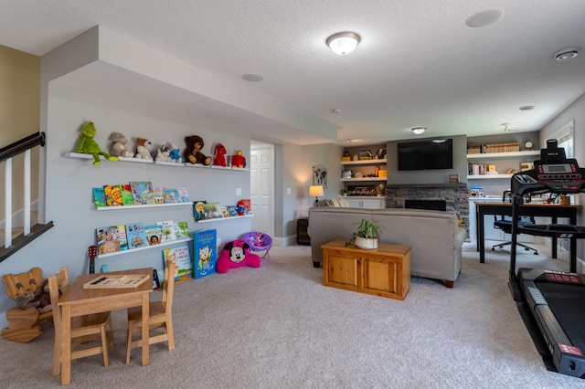 19717 Hazel Nut Ave, Lakeville, MN 55044 - recreation room with light carpet, a textured ceiling, and a stone fireplace