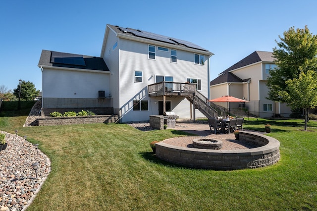 19717 Hazel Nut Ave, Lakeville, MN 55044 - back of house with an outdoor fire pit, a wooden deck, stairway, a patio area, and roof mounted solar panels