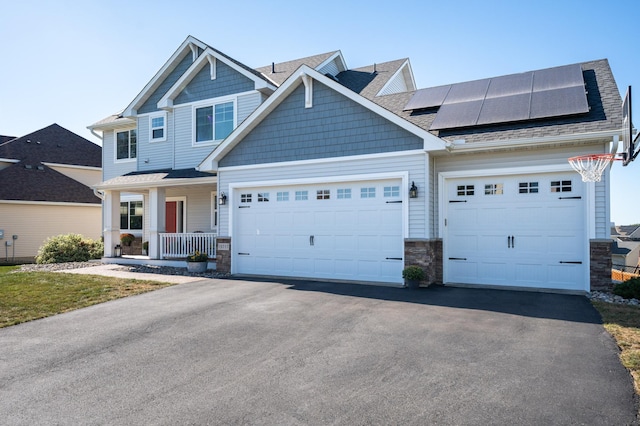 19717 Hazel Nut Ave, Lakeville, MN 55044 - view of front of property featuring stone siding, driveway, covered porch, and a garage