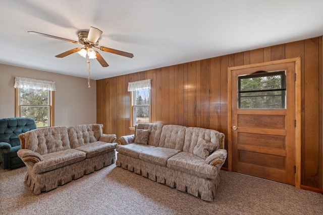 37301 Little Sweden Rd, Nashwauk Twp, MN 55769 - carpeted living area featuring plenty of natural light, wood walls, and a ceiling fan