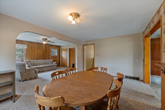 37301 Little Sweden Rd, Nashwauk Twp, MN 55769 - dining room featuring light colored carpet, visible vents, ceiling fan, arched walkways, and baseboards