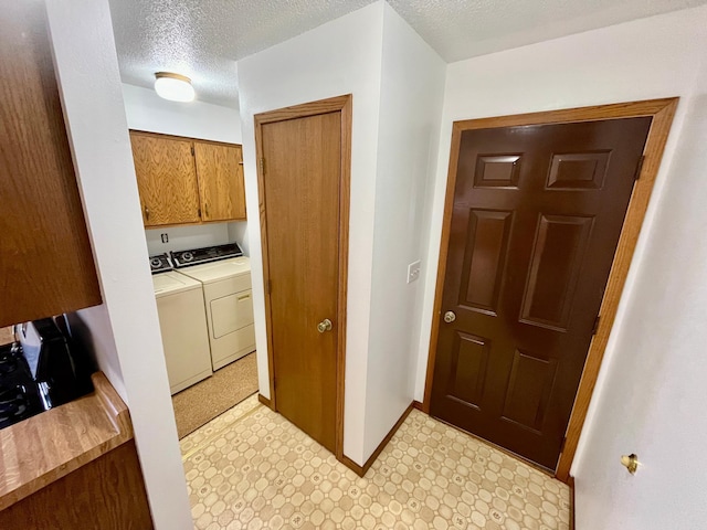 777 Big Round Ave, Georgetown Twp, WI 54853 - laundry room with washer and clothes dryer, light floors, and a textured ceiling