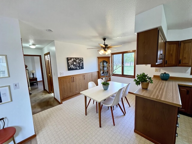 777 Big Round Ave, Georgetown Twp, WI 54853 - dining area featuring baseboards, light carpet, a ceiling fan, and a textured ceiling
