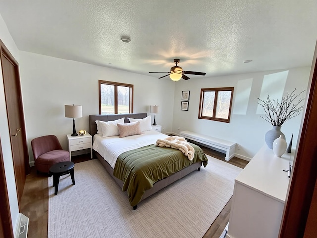 777 Big Round Ave, Georgetown Twp, WI 54853 - bedroom featuring light wood-style floors, a textured ceiling, and multiple windows