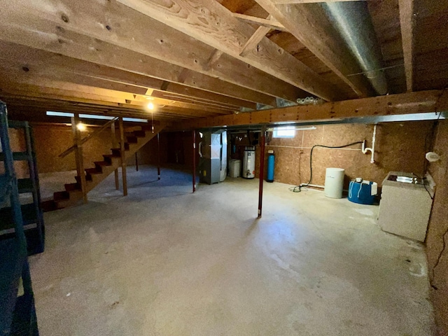 777 Big Round Ave, Georgetown Twp, WI 54853 - basement featuring water heater, heating unit, and stairway
