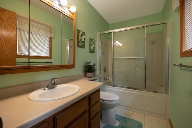bathroom with vanity, bath / shower combo with glass door, toilet, and tile patterned floors