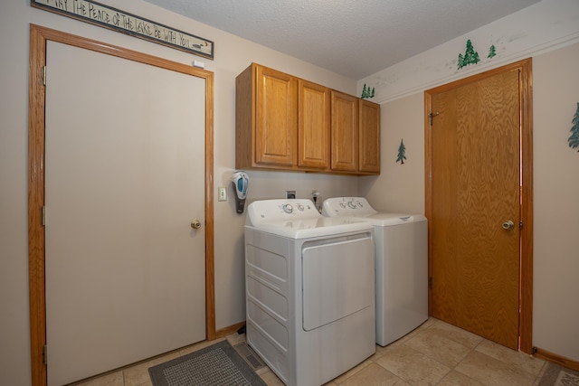 laundry room featuring cabinet space, independent washer and dryer, and a textured ceiling