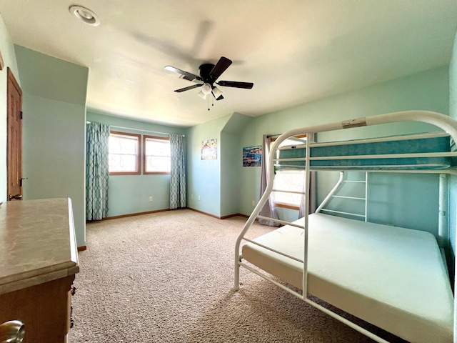 unfurnished bedroom with a ceiling fan, baseboards, and carpet