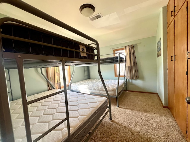 unfurnished bedroom featuring baseboards, visible vents, and light carpet
