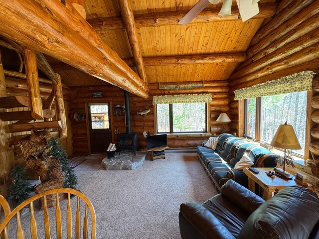 carpeted living room with rustic walls, wood ceiling, and a wood stove
