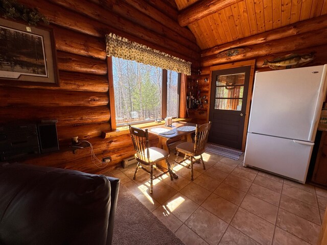 tiled dining area featuring rustic walls, lofted ceiling with beams, and wood ceiling