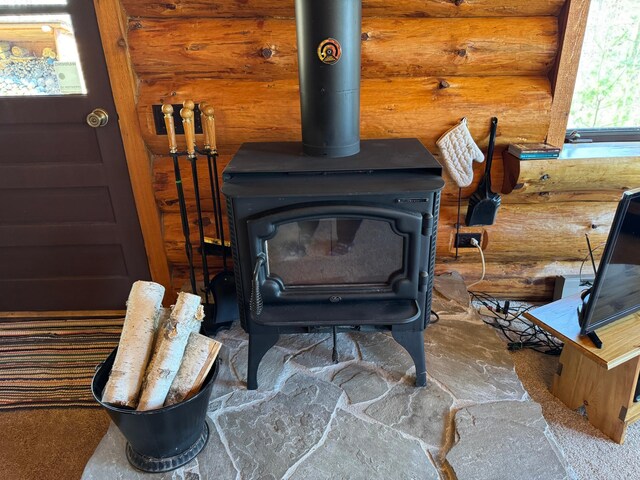 details with a wood stove and log walls
