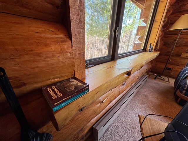 room details with log walls, baseboard heating, and carpet flooring