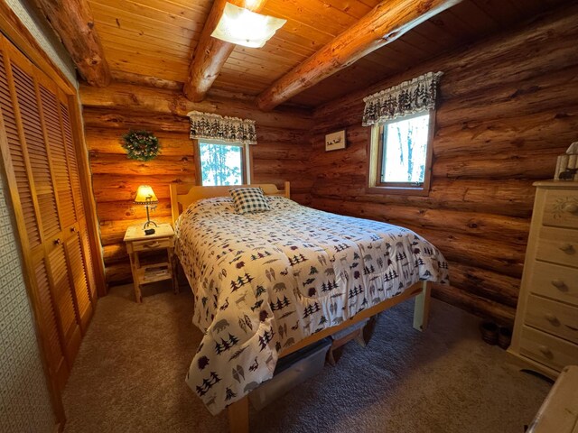 bedroom featuring beamed ceiling, wooden ceiling, log walls, and carpet