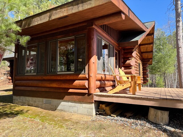 exterior space with crawl space and log exterior