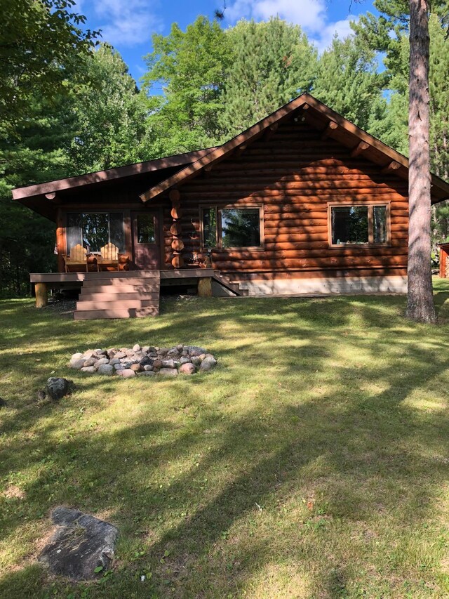 exterior space with log exterior and a yard