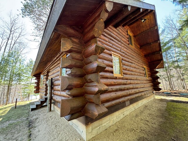 view of property exterior with log exterior