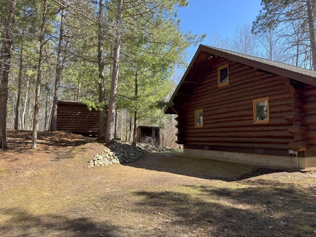 view of side of home featuring log siding