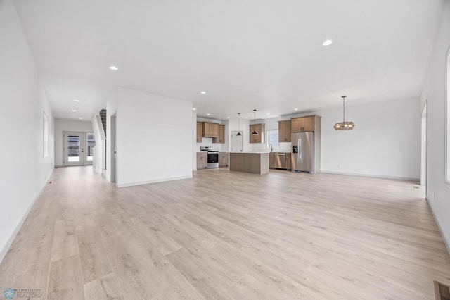 8343 61st St S, Horace, ND 58047 - unfurnished living room featuring light wood finished floors, recessed lighting, and a chandelier