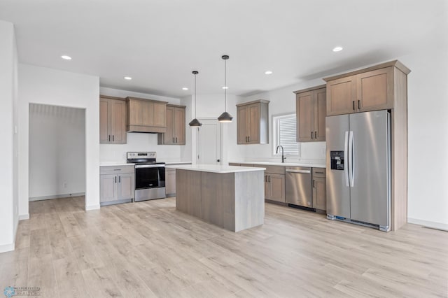 8343 61st St S, Horace, ND 58047 - kitchen with appliances with stainless steel finishes, under cabinet range hood, light wood finished floors, light countertops, and a kitchen island
