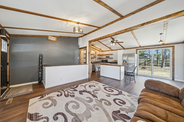 living room featuring visible vents, lofted ceiling with beams, dark wood finished floors, and a ceiling fan