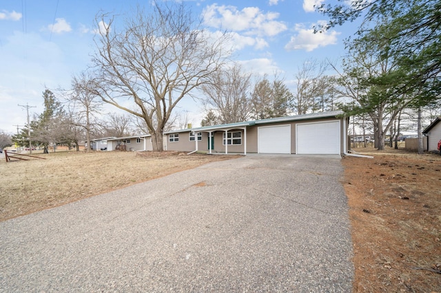 ranch-style house with a porch, a garage, and aphalt driveway