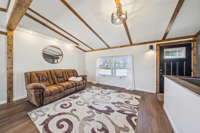 living room with baseboards, lofted ceiling with beams, dark wood-style flooring, and wooden walls